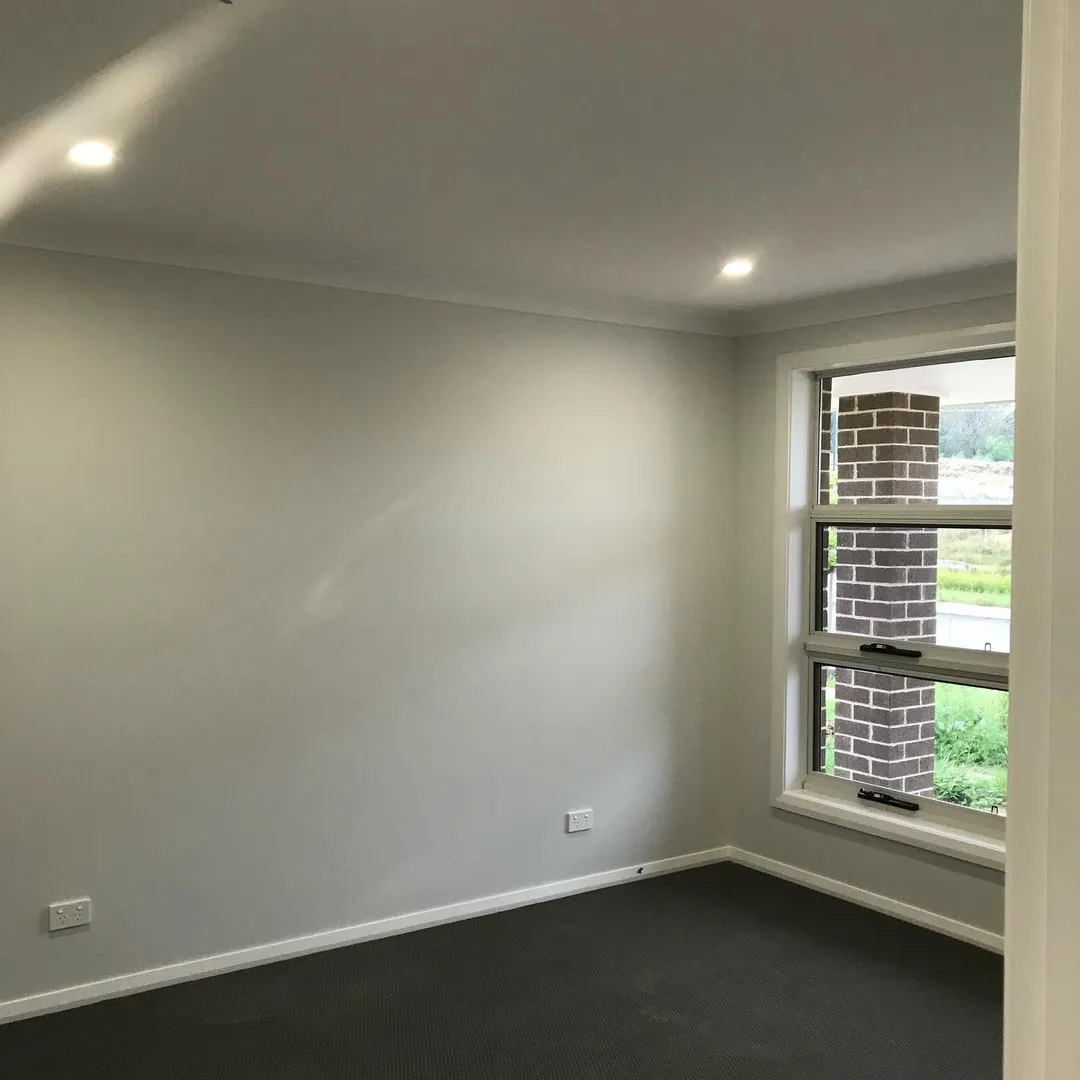 Empty room with window and neutral walls